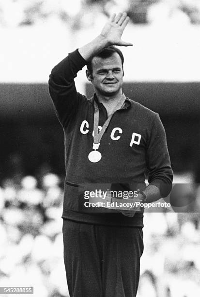 Latvian and soviet athlete Janis Lusis waves from the podium after winning the gold medal and setting an Olympic Record in the javelin throw during...