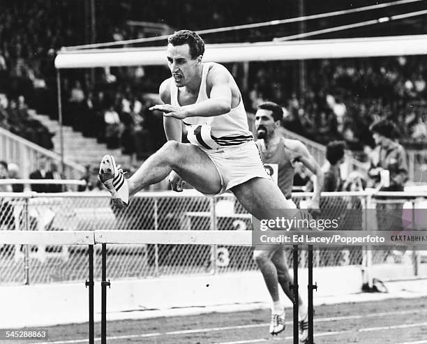 British hurdler John Cooper in action during a 400m hurdles race at White City stadium in London, August 18th 1962.