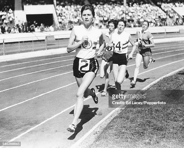 British middle distance runner Diane Leather leads the field during a race, at White City stadium, London, August 3rd 1957.