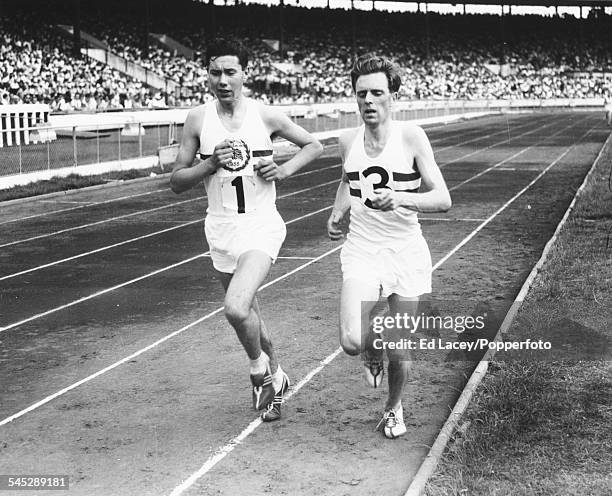 British athletes Ken Norris and Frank Sands are pictured at a dead heat at the close of the 10000m race at an England versus West Germany track and...