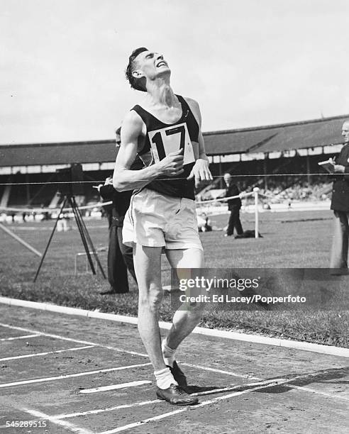 British athlete Stan Vickers crosses the finish line to win the Amateur Athletic Association's 2 mile walk event in 1960.