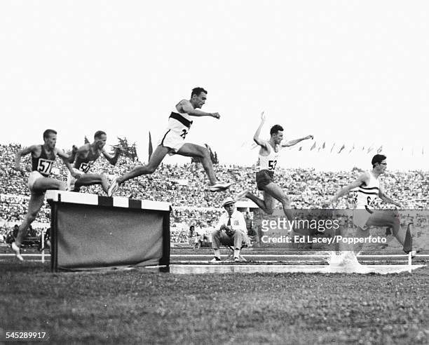British runner Don Chapman leading the race, ahead of Zdzislaw Krzyszkowiak of Poland and Ludwig Muller, during the 3000m steeplechase heats at the...