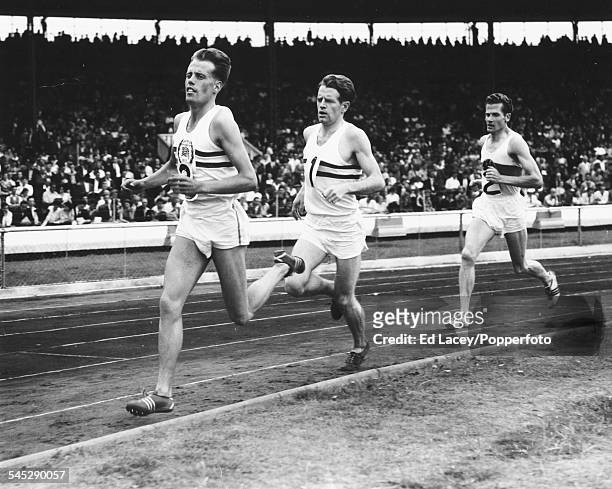 British middle distance runners Derek Ibbotson and Christopher Chataway lead the field at a Great Britain versus West Germany track and field event...