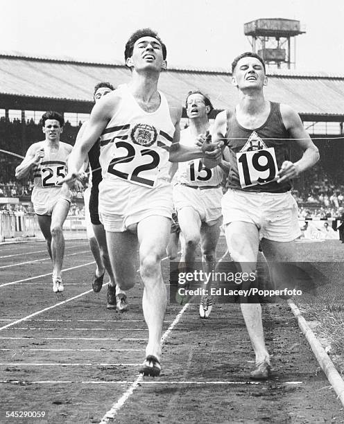 British athlete Derek Johnson crosses the finish line to win the 800 yards race, ahead of Ron Henderson at the Amateur Athletic Association...