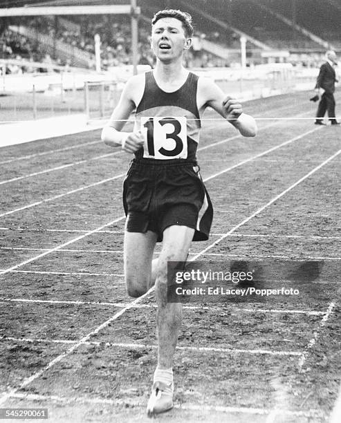 British athlete Ken Norris crosses the finish line to win the six mile race, at the Amateur Athletic Association Championships, White City, London,...