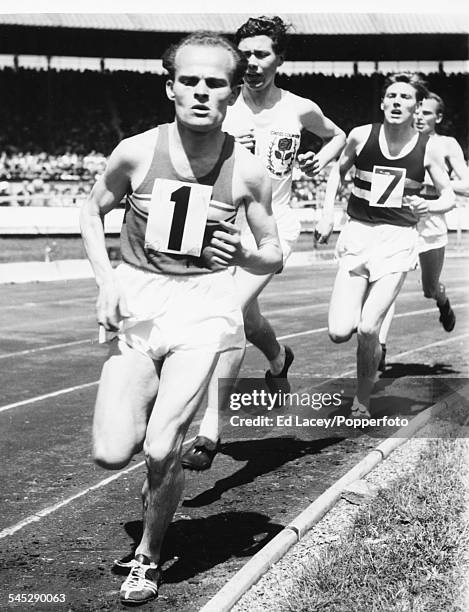 Hungarian athlete Jozsef Kovacs leads the field ahead of Ken Norris and George Knight during the Three mile invitation event at the Inter County...