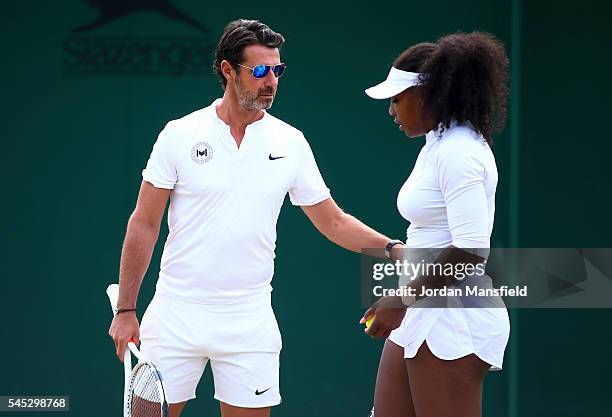 Serena Williams of USA with coach Patrick Mouratoglou during a practice session on day ten of the Wimbledon Lawn Tennis Championships at the All...