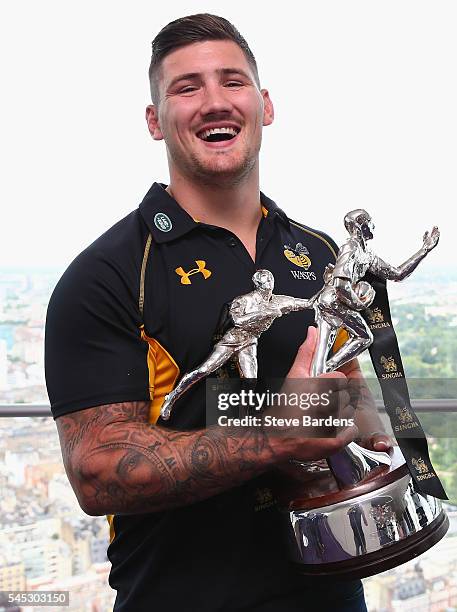 Guy Thompson of Wasps poses with the Singha Sevens Trophy during the 2016-17 Aviva Premiership Rugby Season fixtures announcement at BT Tower on July...