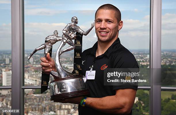 Geraint Rhys Jones of Newport Gwent Dragons poses with the Singha Sevens trophy during the 2016-17 Aviva Premiership Rugby Season fixtures...