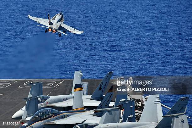 An F/A-18F Super Hornet takes off from the US navy's super carrier USS Dwight D. Eisenhower in the Mediterranean Sea on July 7, 2016. The US aircraft...
