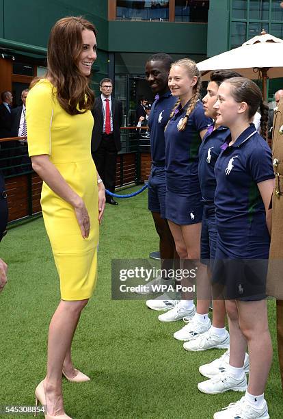 Catherine, Duchess of Cambridge meets ball boys and girls, from left, Dominic Barnaby, Olivia Mallett, Thomas Morais and Anissa Mayouf, during a...