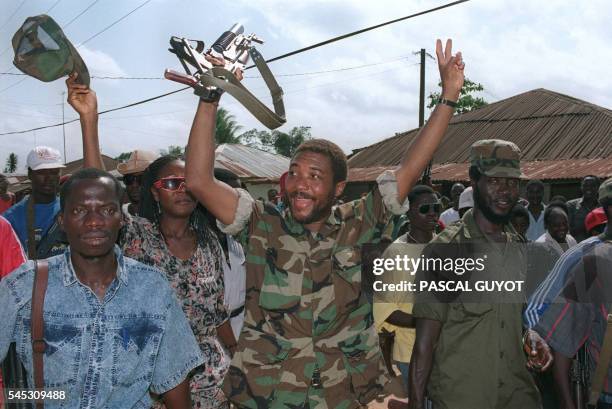 Liberian rebel leader Charles Taylor celebrates with troops on July 21, 1990 in Roberts Field, an airport outside Monrovia, after taking over this...