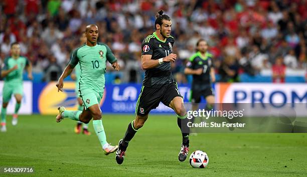 Wales player Gareth Bale in action during the UEFA EURO 2016 semi final between Wales and Portugal at Stade des Lumieres on July 6, 2016 in Lyon,...