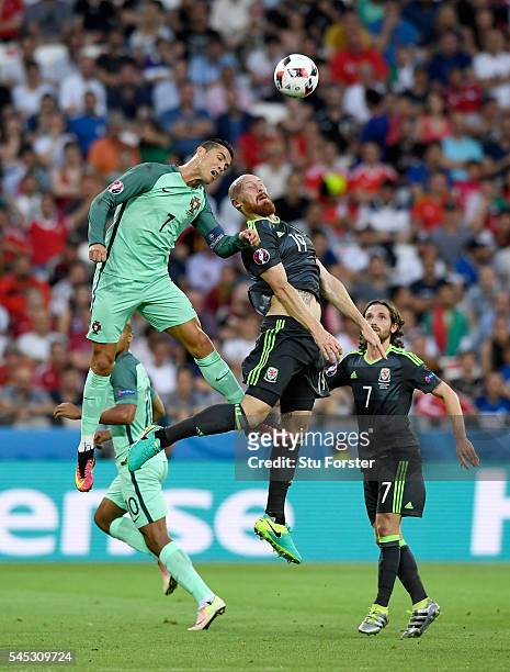 Portugal player Cristiano Ronaldo is challenged by James Collins of Wales during the UEFA EURO 2016 semi final between Wales and Portugal at Stade...