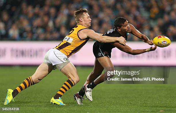 Sam Mitchell of the Hawks tackles Jake Neade of the Power during the 2016 AFL Round 16 match between Port Adelaide Power and the Hawthorn Hawks at...