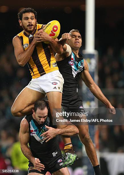 Paul Puopolo of the Hawks flies over Nathan Krakouer of the Power during the 2016 AFL Round 16 match between Port Adelaide Power and the Hawthorn...