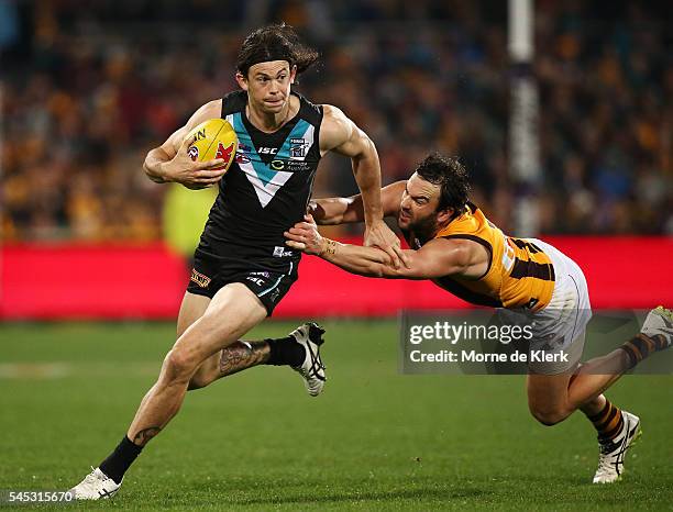 Jasper Pittard of the Power gets away from Jordan Lewis of the Hawks during the round 16 AFL match between the Port Adelaide Power and the Hawthorn...