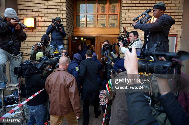 Photographers take pictures as police escort the murder convicted Oscar Pistorius before his sentencing at the Northern Gauteng High Court on July...