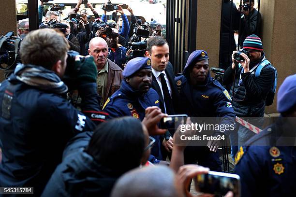 Police escort murder convicted Oscar Pistorius before his sentencing at the Northern Gauteng High Court on July 06, 2016 in Pretoria, South Africa....