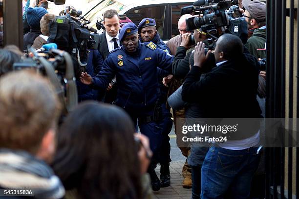 Police escort murder convicted Oscar Pistorius before his sentencing at the Northern Gauteng High Court on July 06, 2016 in Pretoria, South Africa....