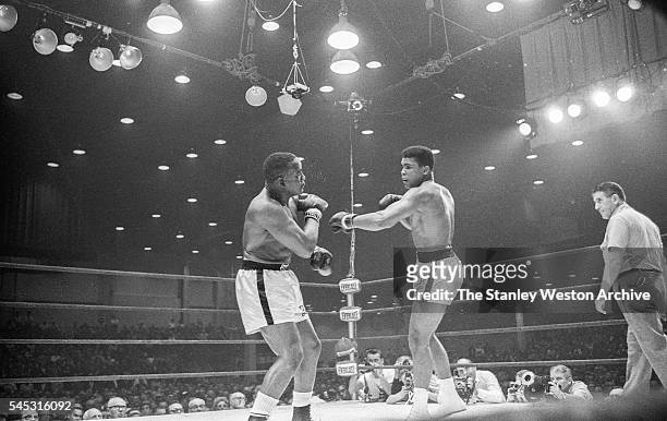 Cassius Clay and Sonny Liston exchange blows during their bout at the Convention Center in Miami Beach, Florida, February 25, 1964. Cassius Clay won...