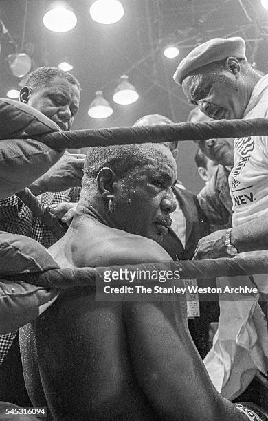 Sonny Liston sits in his corner surrounded by his corner men and press failing to answer the 7th round, at the Convention Center in Miami Beach,...