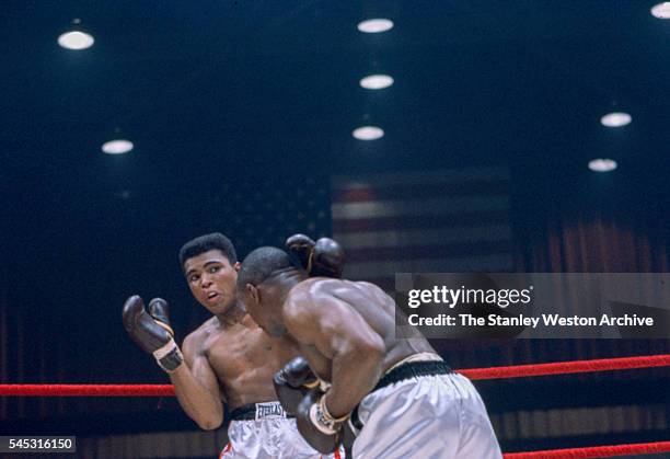 Cassius Clay reacts to a Sonny Liston jab at the Convention Center in Miami Beach, Florida, February 25, 1964. Cassius Clay won the World Heavyweight...