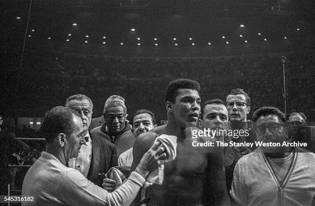 Cassius Clay surrounded by his team after he wins by TKO against Archie Moore at the Sports Arena on November 15, 1962 in Los Angeles, California....