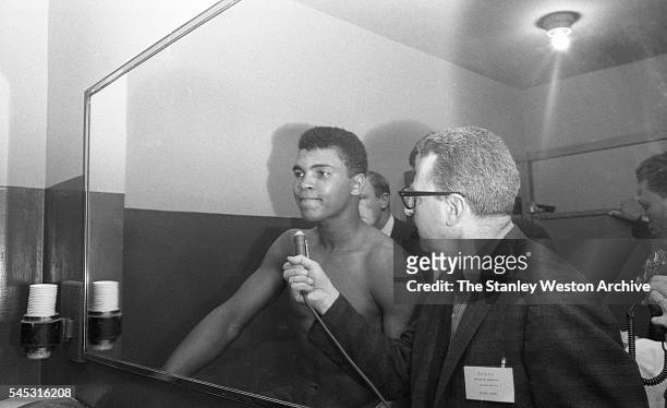 Cassius Clay talks to the press in his locker room afer winning by TKO vs. Doug Jones during their heavyweight bout at Madison Square Garden, New...