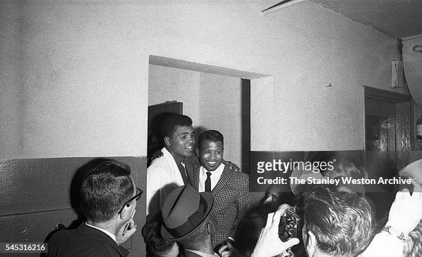 Cassius Clay and former Middleweight champion Sugar Ray Robinson greet the press after his TKO win vs. Doug Jones during their heavyweight bout at...