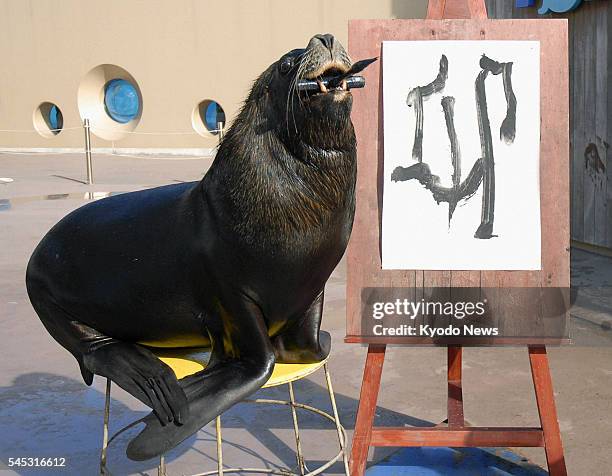 Japan - A male sea lion demonstrates its skill in Japanese calligraphy at Hakkeijima Sea Paradise in Yokohama on Jan. 1, 2011. The sea lion with a...