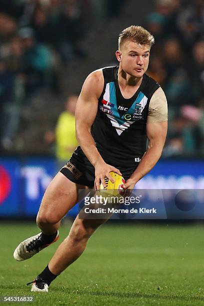Ollie Wines of the Power runs with the ball during the round 16 AFL match between the Port Adelaide Power and the Hawthorn Hawks at Adelaide Oval on...