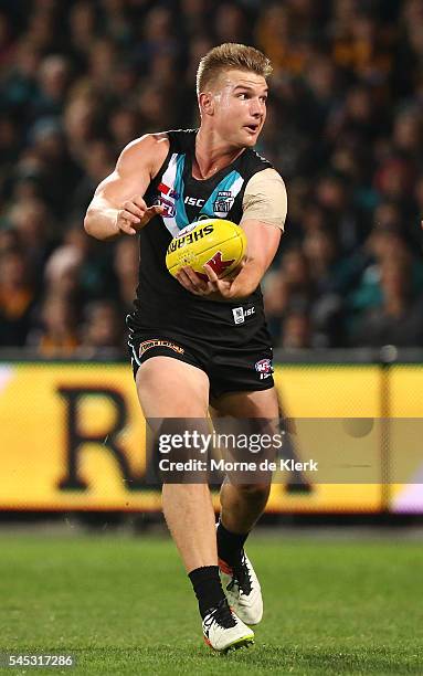 Ollie Wines of the Power runs with the ball during the round 16 AFL match between the Port Adelaide Power and the Hawthorn Hawks at Adelaide Oval on...