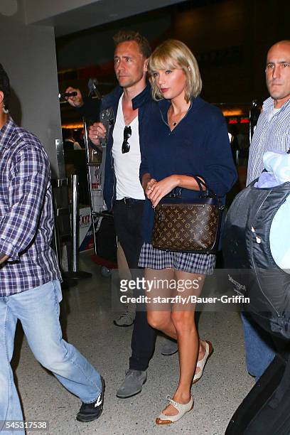 Taylor Swift and Tom Hiddleston are seen at LAX on July 06, 2016 in Los Angeles, California.