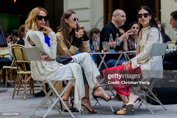 Candela Novembre, Giorgia Tordini and Gilda Ambrosio sitting ina cafe in Paris drinking Coca Cola outside Viktor & Rolf during Paris Fashion Week...