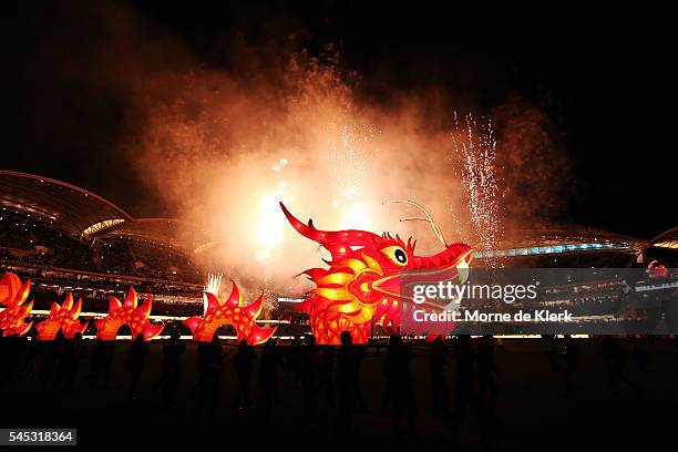 Fireworks and a Chinese dragon is seen on the oval as part of the multicultural round celebrateions before the round 16 AFL match between the Port...