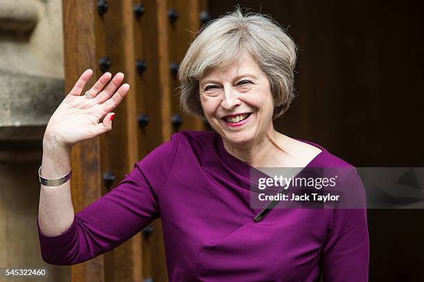 British Home Secretary and Conservative leadership contender Theresa May waves outside the Houses of Parliament on July 7, 2016 in London, England....