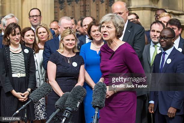 British Home Secretary and Conservative leadership contender Theresa May waves outside the Houses of Parliament on July 7, 2016 in London, England....