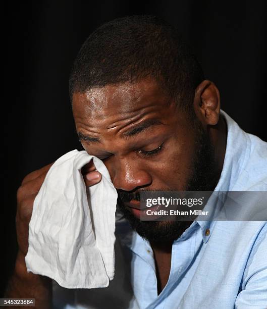 Mixed martial artist Jon Jones wipes away tears while speaking during a news conference at MGM Grand Hotel & Casino to address being pulled from his...
