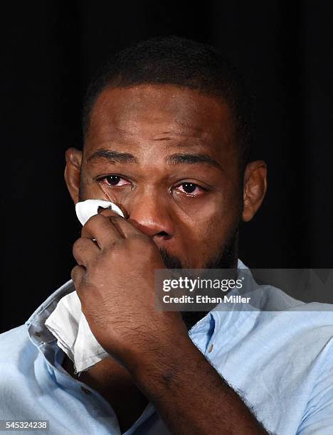 Mixed martial artist Jon Jones wipes away tears while speaking during a news conference at MGM Grand Hotel & Casino to address being pulled from his...