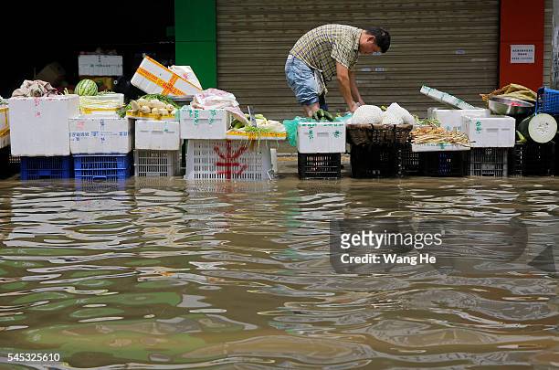 Vendors selling vegetables in the flooded of South Lake Community, Wuhan, Hubei Province of China on 7 July 2016.