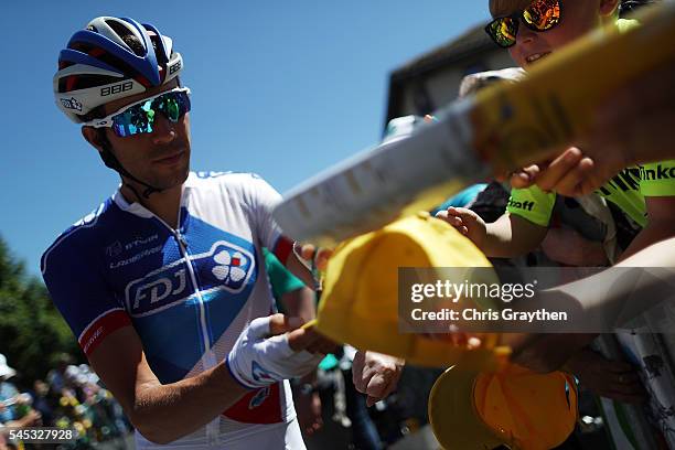 Thibaut Pinot of France riding for FDJ signs autographs prior to stage six of the 2016 Le Tour de France a 190.5km stage from Arpajon-Sur-Cere to...