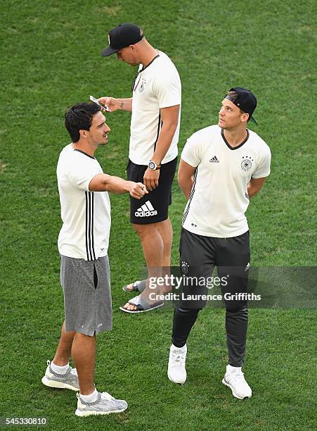 Mats Hummels, Lukas Podolski and Manuel Neuer of Germany talk during the pitch inpection prior to the UEFA EURO semi final match between Germany and...