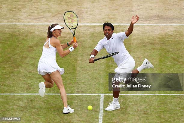 Leander Paes of India and Martina Hingis of Switzerland in acton during the Mixed Doubles third round match against Henri Kontinen of Finland and...