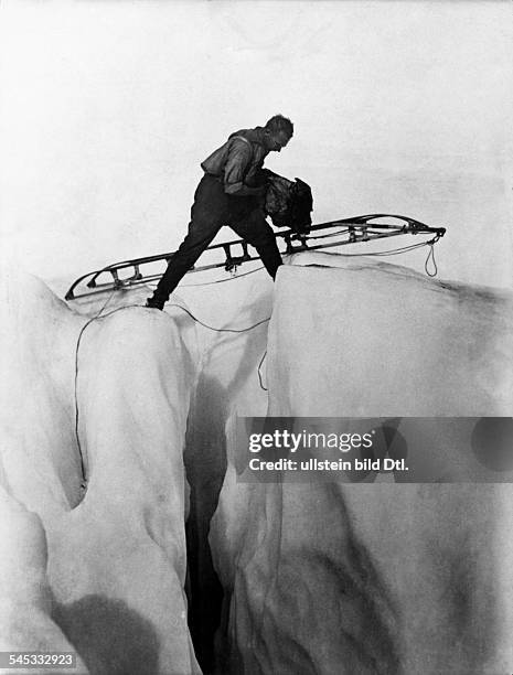 German geophysicist and meteorologist. Photographed crossing a glacier during his final expedition to Greenland, November 1930.