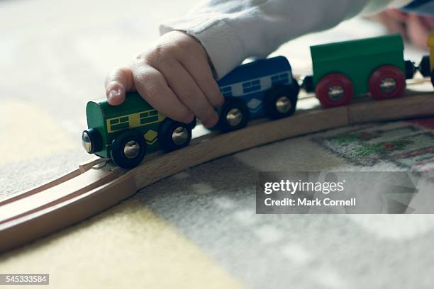 child's hand playing with toy train - model train stock pictures, royalty-free photos & images