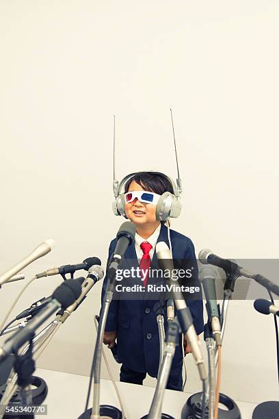 young japanese boy with headset and microphones - scandal press conference stock pictures, royalty-free photos & images