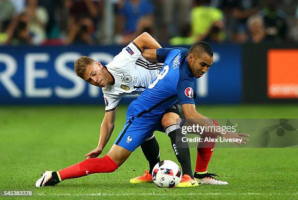 Dimitri Payet of France controls the ball under pressure of Joshua Kimmich of Germany during the UEFA EURO semi final match between Germany and...