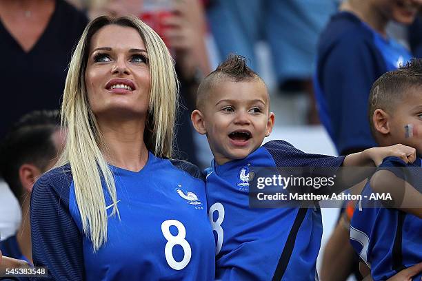 Dimitri Payet's wife Ludivine Payet looks on with their son prior to the UEFA Euro 2016 Semi Final match between Germany and France at Stade...