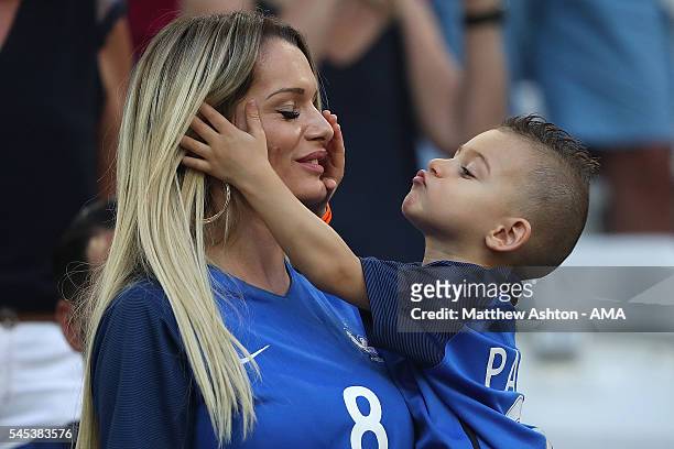 Dimitri Payet's wife Ludivine Payet looks on with their son prior to the UEFA Euro 2016 Semi Final match between Germany and France at Stade...